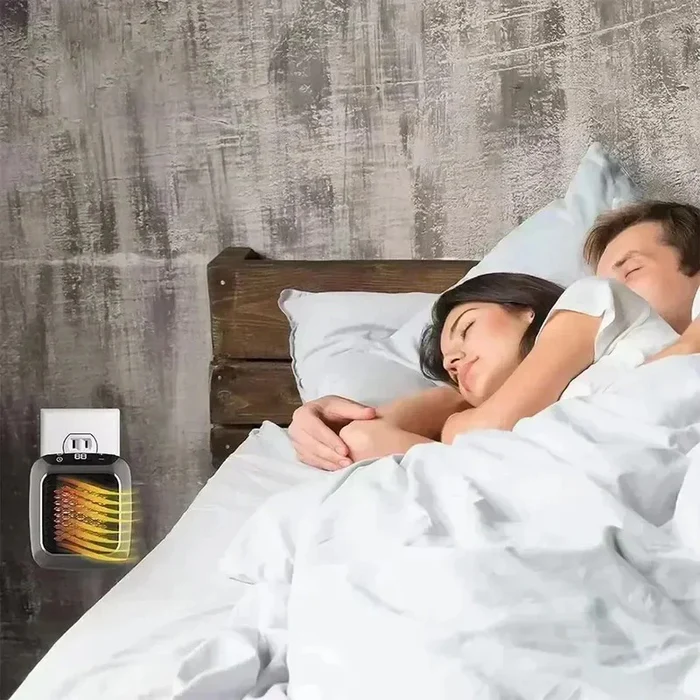 Casal dormindo com aquecedor portatil ao lado